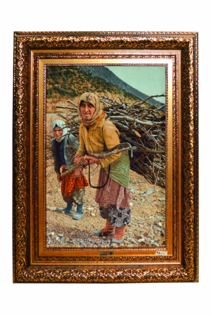 A rural woman carrying firewood